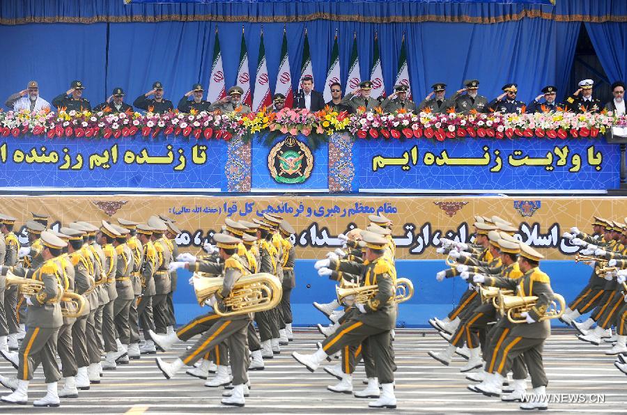 Iranian President Mahmoud Ahmadinejad (C Back) reviews the soldiers marching during the Army Day parade in Tehran, Iran, April 18, 2013. Ahmadinejad said that the Iranians will maintain security of Persian Gulf through a collective work of regional states. (Xinhua/Abolfazl Nesaei) 