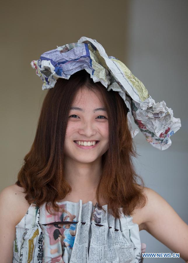 A model presents a creation made of newspaper during a "low-carbon fashion show" in Huaibei, east China's Anhui Province, April 18, 2013. Students of the Huaibei Normal University and employees of local power supply company were involved on the event held to call for environmental protection. (Xinhua/Wang Wen) 