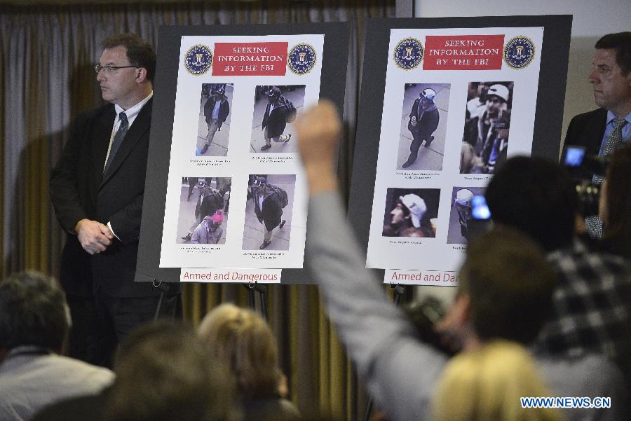 Photos of two suspects for the Boston Marathon bombings are seen during a press conference to release their photos and video in Boston, April 18, 2013. The FBI special agent Richard DesLauriers on Thursday released the photos and video of two suspects for Monday's deadly bombings in Boston, asking for the public's help to identify them. (Xinhua/Zhang Jun)