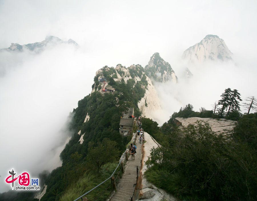 Located in Huayin City, about 120 kilometres east of the city of Xi'an, Mount Hua, one of China's Five Great Mountains, is holy ground for Taoism. It features over 20 Taoist temples, of which the Jade Spring and Zhenyue Palaces are the most famous. It has five peaks, east, west, south, north and central, of which the highest is the South Peak at 2154.9m. Aside from these elements, it is also one of the nine best places to see the sun rise in China. Chaoyang Peak is the best place to watch the sunrise. (China.org.cn)