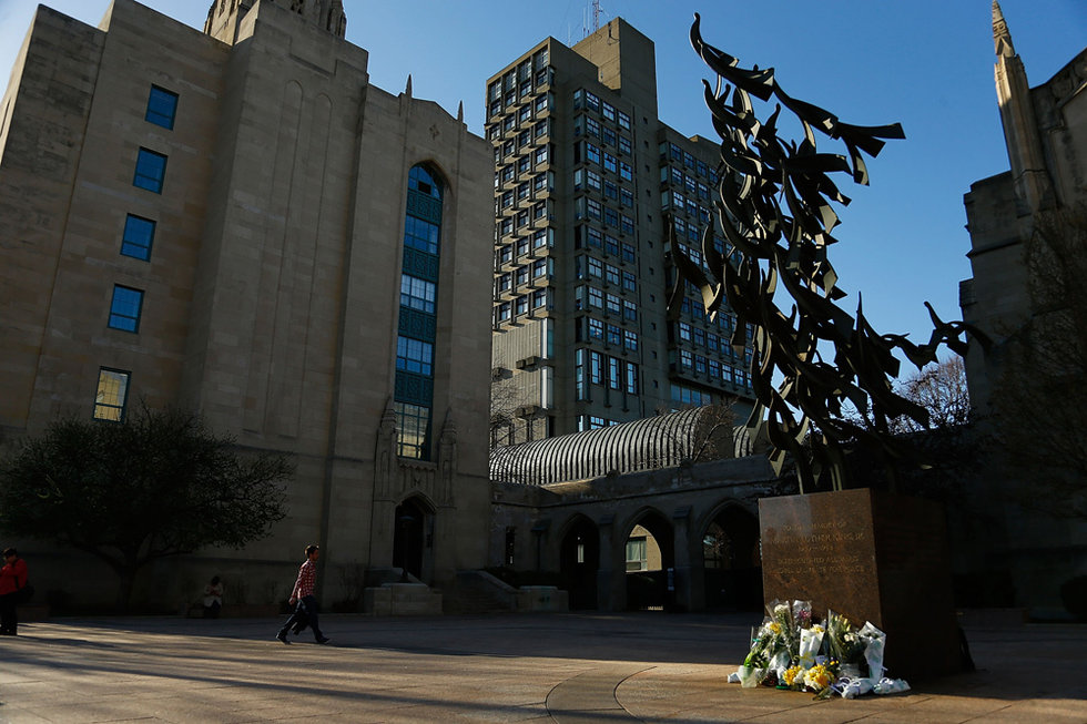 Students offer flowers to Lu Lingzi, a Chinese victim in Boston marathon blast, in Boston University on April 17.