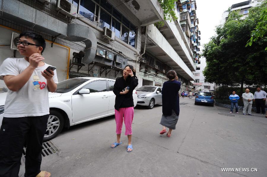 Citizens gather outside their apartments to avoid aftershocks of an earthquake, in Chongqing, adjacent to southwest China's Sichuan Province, April 20, 2013. A 7.0-magnitude earthquake hit Lushan County of Sichuan Province at 8:02 a.m. Beijing Time (0002 GMT) on Saturday, according to the China Earthquake Networks Center (CENC). The epicenter, with a depth of 13 kilometers, was monitored at 30.3 degrees north latitude and 103.0 degrees east longitude. Residents in Chongqing felt the earthquake. (Xinhua/Li Jian) 