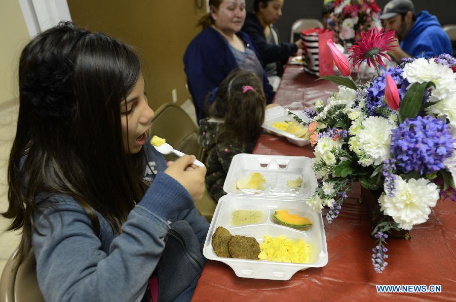 A child who was evacuated from the fertilizer plant blast affected area has breakfast in a church in West, Texas, the United States, April 19, 2013. The massive explosion at a Texas fertilizer plant on Wednesday has killed 14 people and injured more than 160 others, local authorities said Thursday. Texas Governor Rick Perry has declared McLennan County a disaster area, saying he would ask for federal disaster aid from President Barack Obama. (Xinhua/Wang Lei) 