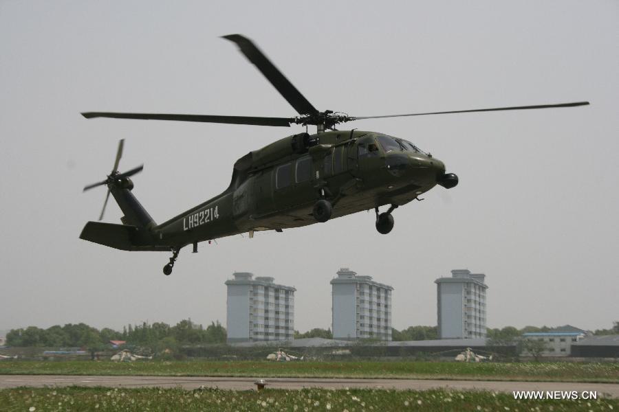 A military helicoptor takes off and will fly for the quake-hit areas of southwest China's Sichuan Province, April 20, 2013. A 7.0-magnitude earthquake earthquake hit Lushan county of Ya'an City in Sichuan at 8:02 a.m. Saturday Beijing Time. At least 113 people were confirmed dead by far. (Xinhua/Xia Rui) 