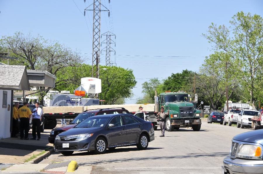 Rescue vehicle are seen in West, Texas, the United States, April 20, 2013. The Authorities of the city of West, the U.S. state of Texas, on Saturday declared to impose curfew while allowing some of the evacuated residents to return home in the afternoon, more than two days after a powerful explosion at a local fertilizer plant that almost razed the town. (Xinhua/Zhang Yongxing) 