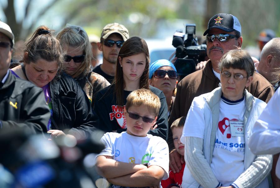 Local residents listen to the news of imposing curfew in West, Texas, the United States, April 20, 2013. The Authorities of the city of West, the U.S. state of Texas, on Saturday declared to impose curfew while allowing some of the evacuated residents to return home in the afternoon, more than two days after a powerful explosion at a local fertilizer plant that almost razed the town. (Xinhua/Wang Lei) 