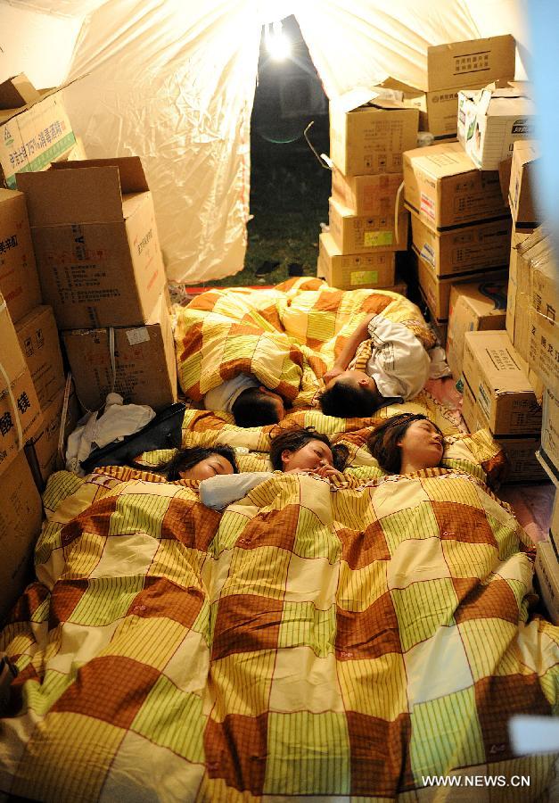 Medical staff of the Red Cross Society of China have a rest in a temporary tent in Lushan County of Ya'an City, southwest China's Sichuan Province, April 21, 2013. A 7.0-magnitude earthquake jolted Lushan County on April 20 morning and by now more than 330 medical workers and voluteers from the Red Cross Society conduct relief work in the quake-hit region. (Xinhua/He Junchang)  