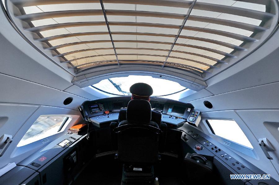 A locoman drives a train on the Harbin-Dalian high-speed railway in Changchun, capital of northeast China's Jilin Province, April 21, 2013. The Harbin-Dalian High-speed Railway, the world's fastest railway in frigid regions, started its summer schedule as of April 21, with the speed during the summer period (usually from April to November) lifted to 300 kilometers per hour from 200 in the winter period, cutting the shortest running time between Harbin and Dalian from five hours and 18 miniutes to three and half hours. The Harbin-Dalian high-speed railway was open for service on Dec. 1, 2012. (Xinhua/Zhang Nan)