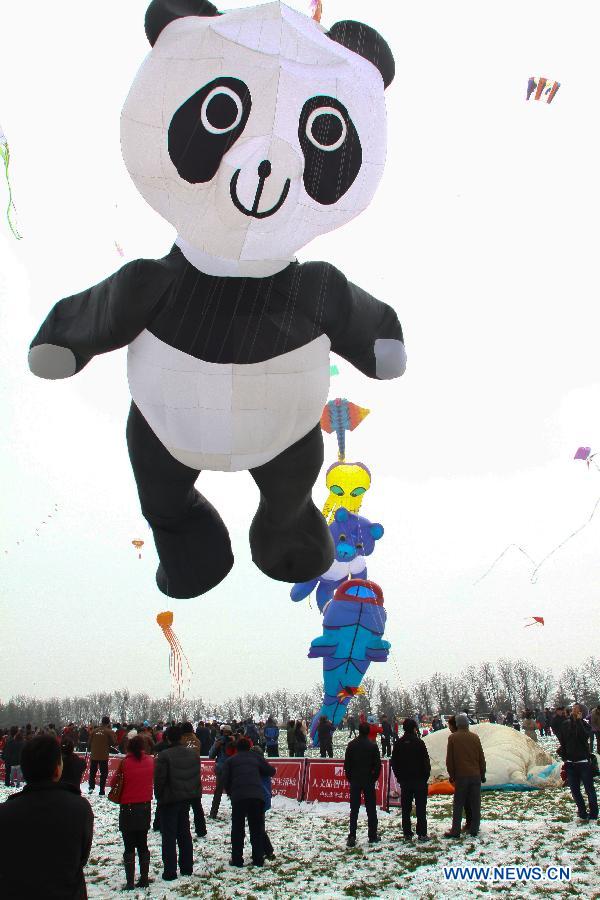 Participants fly kites at the 30th Weifang International Kite Festival in Weifang, east China's Shandong Province, April 20, 2013. Kite-making in Weifang, known as "Kite Capital," can be traced back to the late 16th century and the early 17th century. (Xinhua/Zhang Chi)