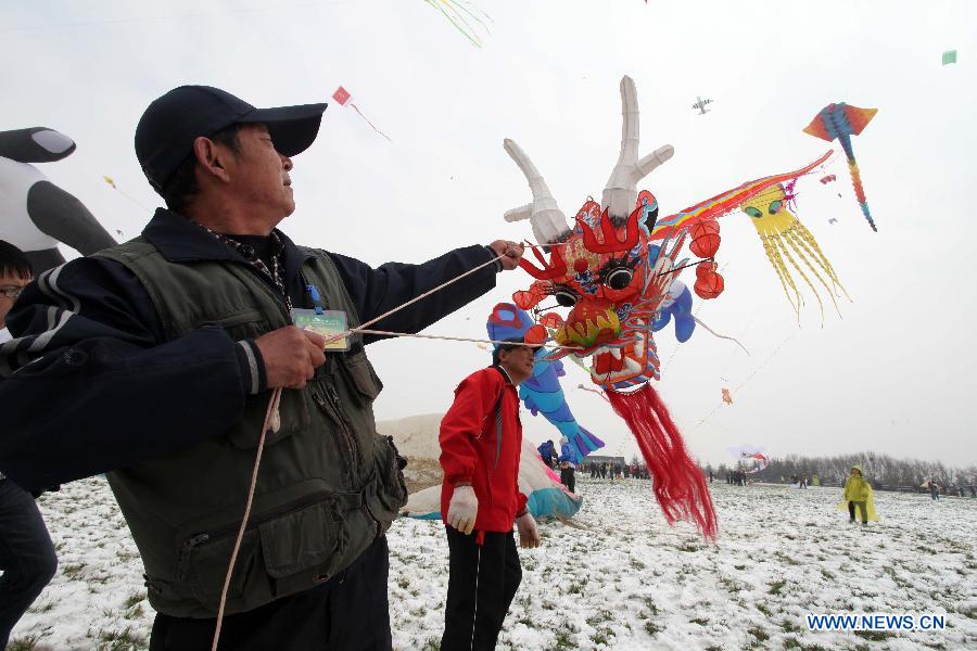 Participants fly kites at the 30th Weifang International Kite Festival in Weifang, east China's Shandong Province, April 20, 2013. Kite-making in Weifang, known as "Kite Capital," can be traced back to the late 16th century and the early 17th century. (Xinhua/Zhang Chi)