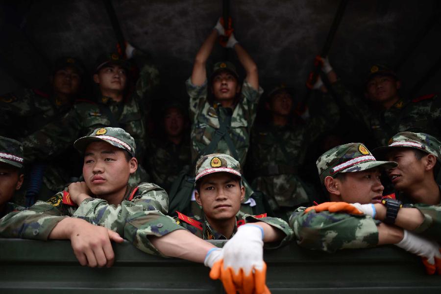 Soldiers arrive in the severely-hit Taiping Town of Lushan County in Ya'an City, southwest China's Sichuan Province, April 21, 2013. The road linking Longmen and Baosheng was reopened on Sunday, making the life passage for Taiping Town and Baosheng Town open. A 7.0-magnitude earthquake jolted Lushan County on April 20. (Xinhua/Jiang Hongjing) 