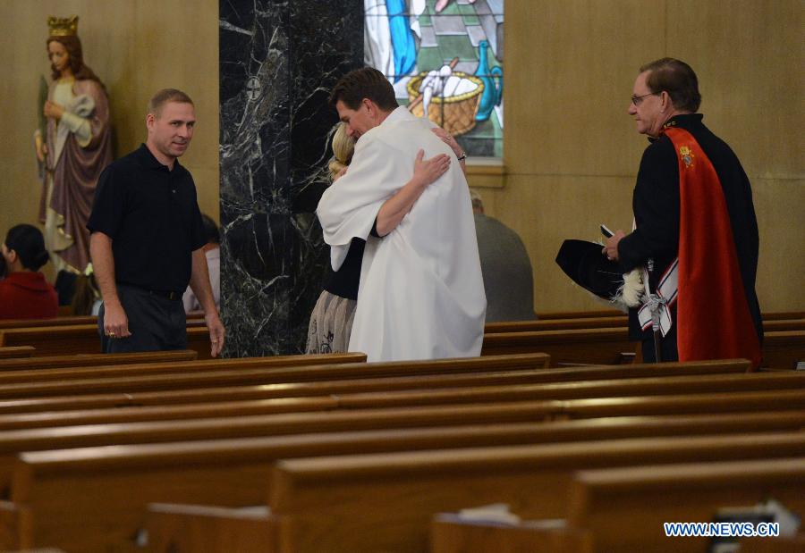 Local residents attend a commemoration ceremony for the deceased people during the furtilizer explosion at a church in West, Texas, April 21, 2013. The powerful blast occurred around 7:50 p.m. local time Wednesday at the fertilizer plant in West, a small town some 320 km north of Houston, Texas, killing at least 14 people and injuring about 200 others. Another 60 remained unaccounted for in the blast, according to local officials. (Xinhua/Wang Lei) 