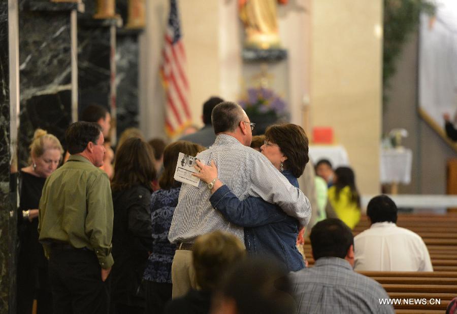 Local residents attend a commemoration ceremony for the deceased people during the furtilizer explosion at a church in West, Texas, April 21, 2013. The powerful blast occurred around 7:50 p.m. local time Wednesday at the fertilizer plant in West, a small town some 320 km north of Houston, Texas, killing at least 14 people and injuring about 200 others. Another 60 remained unaccounted for in the blast, according to local officials. (Xinhua/Wang Lei) 