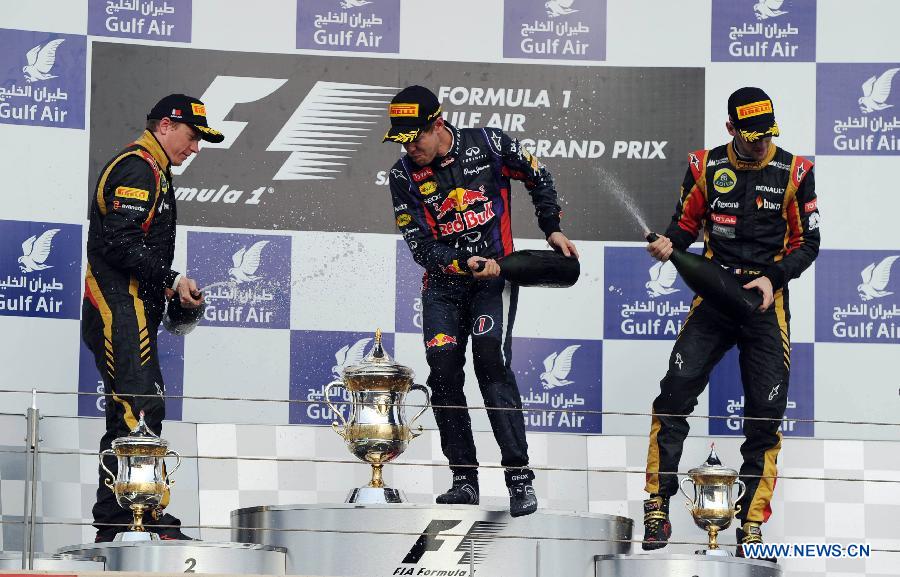 Red Bull driver Sebastian Vettel (C), Lotus driver Kimi Raikkonen (L) and Lotus driver Romain Grosjean celebrate during the victory ceremony of the Bahrain F1 Grand Prix at the Bahrain International Circuit in Manama, Bahrain, on April 21, 2013. (Xinhua/Chen Shaojin)