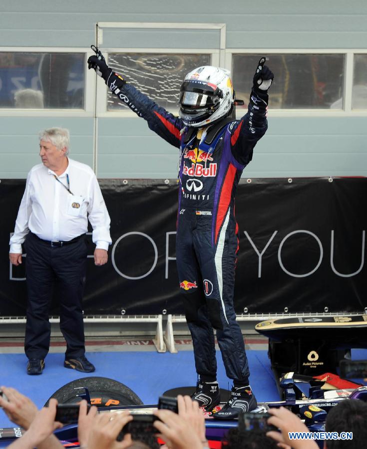 Red Bull driver Sebastian Vettel celebrates during the victory ceremony of the Bahrain F1 Grand Prix at the Bahrain International Circuit in Manama, Bahrain, on April 21, 2013. (Xinhua/Chen Shaojin)