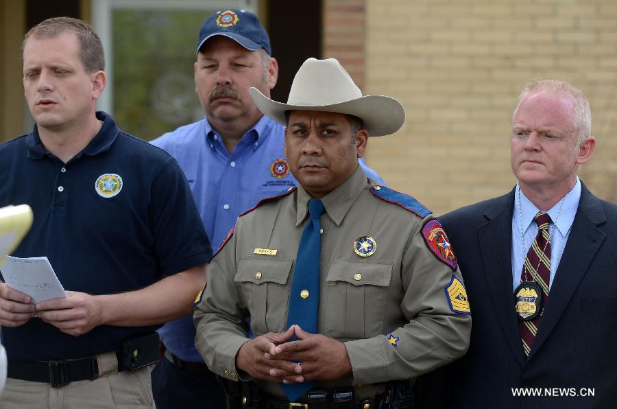 Jason Reyes (Front, C) with Texas Department of Public Safety addresses a news conference in West, Texas, the United States, on April 21, 2013. The seat, or center of an explosion that blew off a fertilizer plant and almost razed the U.S. town of West had been located, a U.S. Official said Sunday. Assistant Texas fire marshal Kelly Kistner told a press conference here that the locationing of the center of the explosion is important to the investigation of the blast. But he said the cause of the fire and blast remained unknown. The explosion left a large crater in the middle of the plant, said Kistner, but declined to elaborate on the dimension of the crater or give other details. (Xinhua/Wang Lei)