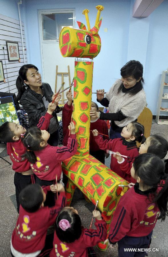 Teachers and students make a model of giraffe using waste materials during an environment protection activity in Handan, north China's Hebei Province, April 22, 2013. The environment protection activity was held to mark the World Earth Day, which falls on April 22 each year. (Xinhua/Hao Qunying)