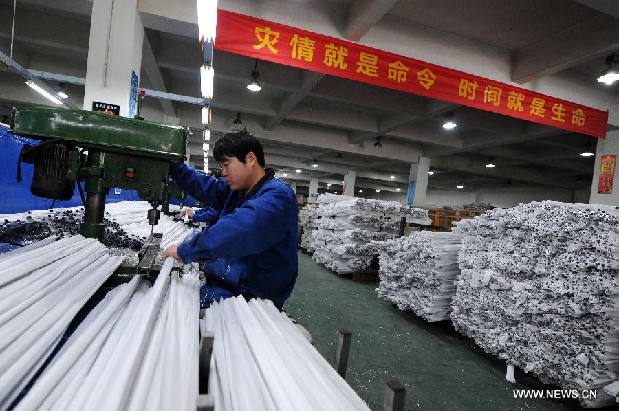 A worker makes tents for disaster relief at a company in Deqing County in east China's Zhejiang Province, April 22, 2013. The first 500 tents made by the company are to be sent to southwest China's Sichuan Province, where a 7.0-magnitude earthquake jolted Lushan County of Ya'an City in the morning on April 20. (Xinhua/Ju Huanzong)