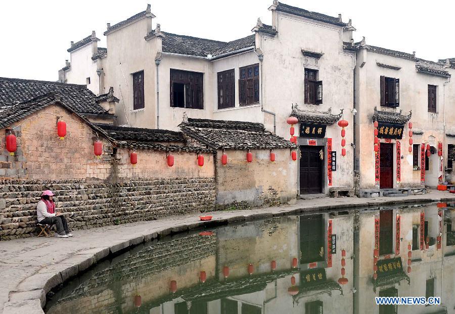 A student draws pictures in Hongcun Village, a famous tourist site in east China's Anhui Province, April 22, 2013. Hongcun, one of the UNESCO World Heritage Sites, took on beautiful spring view and attracted lots of art students. (Xinhua/Wang Song)