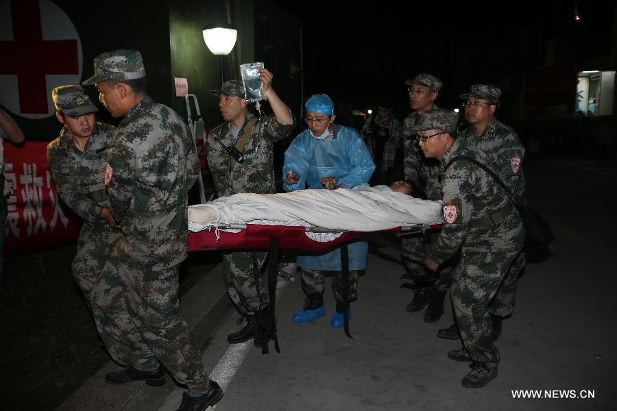 Medical workers transfer Liu Li, mother of the newborn child Zhang An, after childbirth in the quake-hit Lushan County, southwest China's Sichuan Province, April 22, 2013. Liu Li, a villager of Luyang Township of Lushan County, gave birth to the baby girl Zhang An on Monday night. A 7.0-magnitude earthquake jolted Lushan County on April 20, leaving at least 192 people dead and 23 missing. More than 11,000 people were injured. (Xinhua/Jin Liwang) 