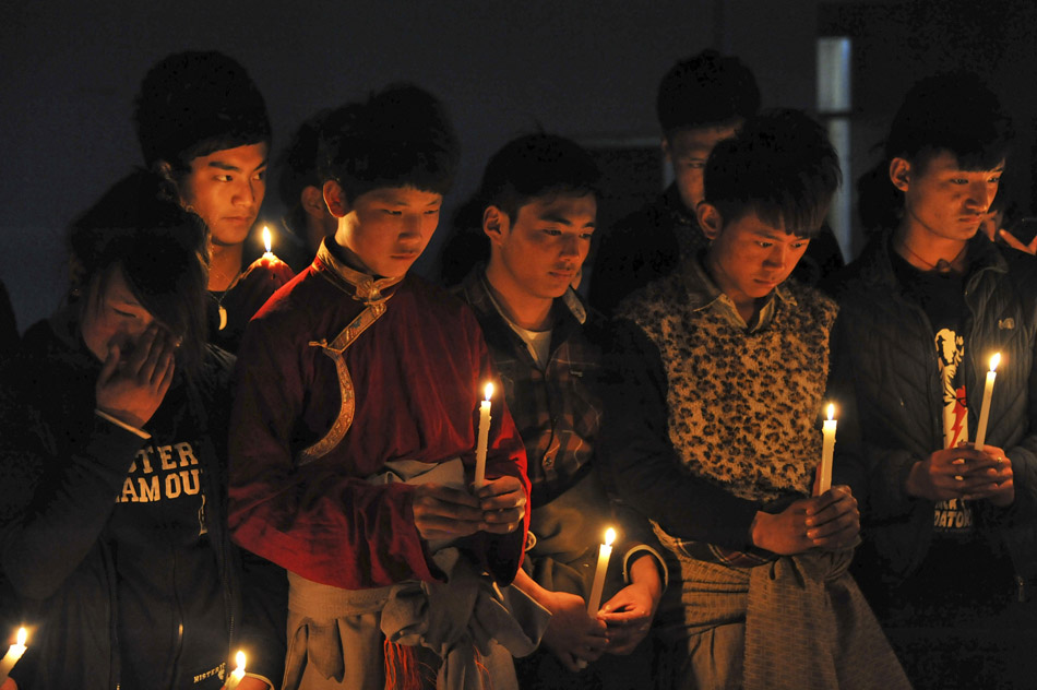 Students from Yushu of Qinghai province, who study in Vocational College in Binzhou of Shandong province, mark the 3rd anniversary of Yushu earthquake. (Xinhua/Li Mo)