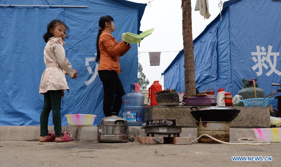 A woman and a youg girl wash their hands after getting up in the morning at a temporary settlement for quake-affected people in Lushan County, southwest China's Sichuan Province, April 23, 2013. A 7.0-magnitude earthquake jolted Lushan County on April 20, leaving at least 192 people dead and 23 missing. More than 11,000 people were injured. (Xinhua/Li Gang)