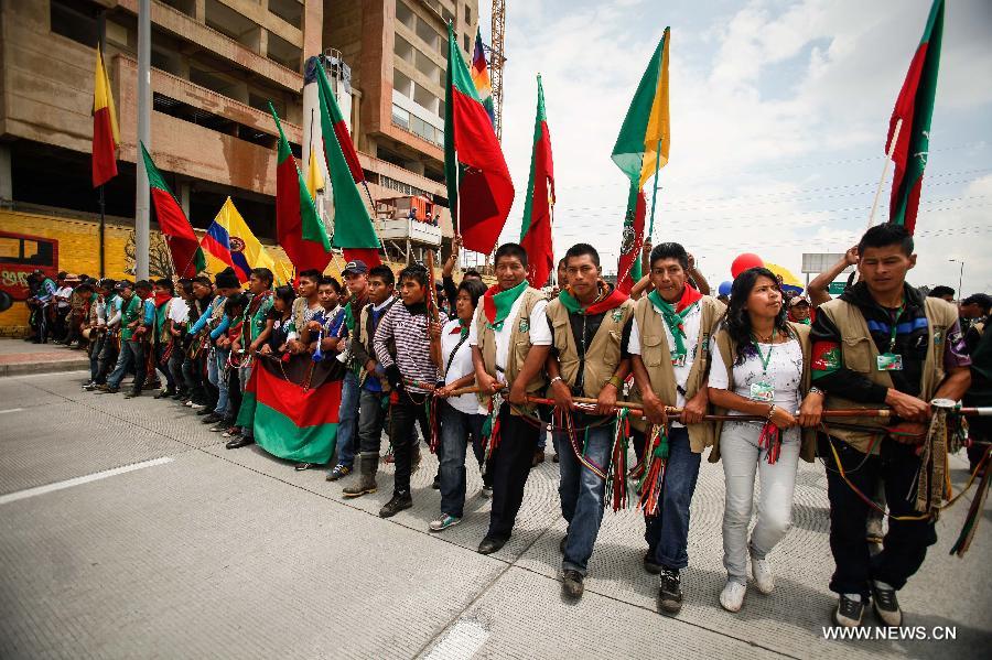 Residents march during the closing ceremony of the "Congress for Peace" in Bogota, capital of Colombia, on April 22, 2013. The "Congress for Peace", organized by the Congress of the People, and attended by some 20,000 people and delegates from 16 countries and regions, ended Monday with a proposed social agenda aimed at finding a solution to the armed conflict in the country, according to local media. (Xinhua/Jhon Paz)