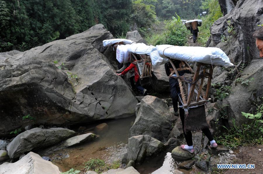 Villagers carrying disaster relief supplies walk in the mountain in quake-hit Shifeng Village of Lushan County, southwest China's Sichuan Province, April 22, 2013. The road linking the Shifeng Village with the outside had been destroyed by a 7.0-magnitude earthquake on April 20. Local villagers set up a 300-member group to climb mountains to get relief supplies outside and then return to the village. Over 40 tonnes of materials had been transported and distributed to over 2,000 villagers. (Xinhua/Li Ziheng)