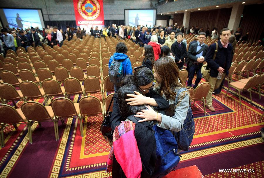 Friends embrace after Boston bombing victim Lu Lingzi's memorial service at Metcalf Hall in Boston University in Boston, the United States, on April 22, 2013. Lu Lingzi, a Boston University student from China, was killed in the deadly Boston Marathon explosions on April 15. (Xinhua/Pool/Boston Globle)