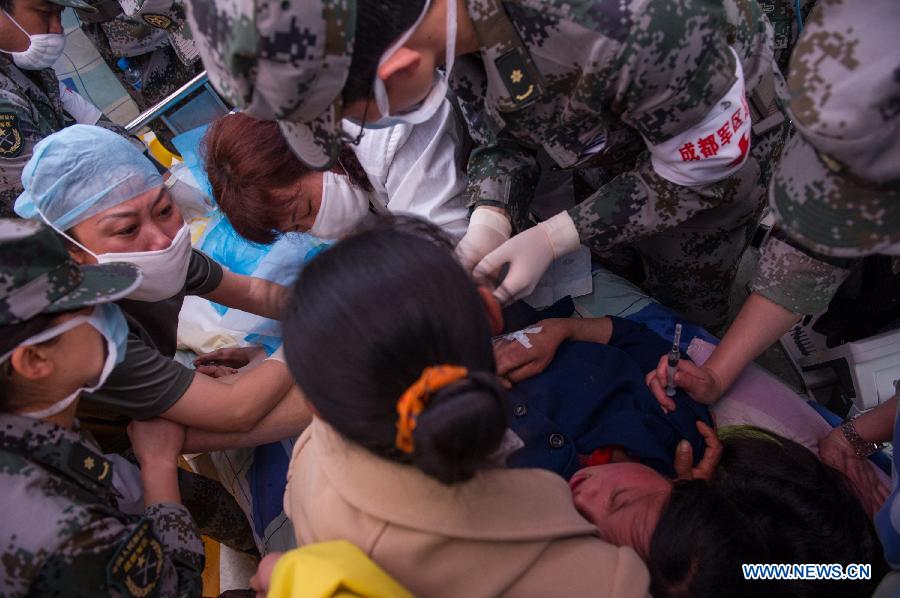 Medical workers take care of Yang Yan, a 20-year-old woman, in childbirth in a tent functioned as temporary hospital in quake-hit Taiping Township of Lushan County, southwest China's Sichuan Province, April 23, 2013. Yang's son was born later, and both mother and baby were fine. Yang and her husband Chen Wei arrived at the hospital in the early morning on Tuesday, after taking a long journey for over three hours from their home in Xingmin Village of the Taiping Township. This was the fourth day after a 7.0-magnitude earthquake jolted Lushan County on April 20. (Xinhua/Chen Cheng)