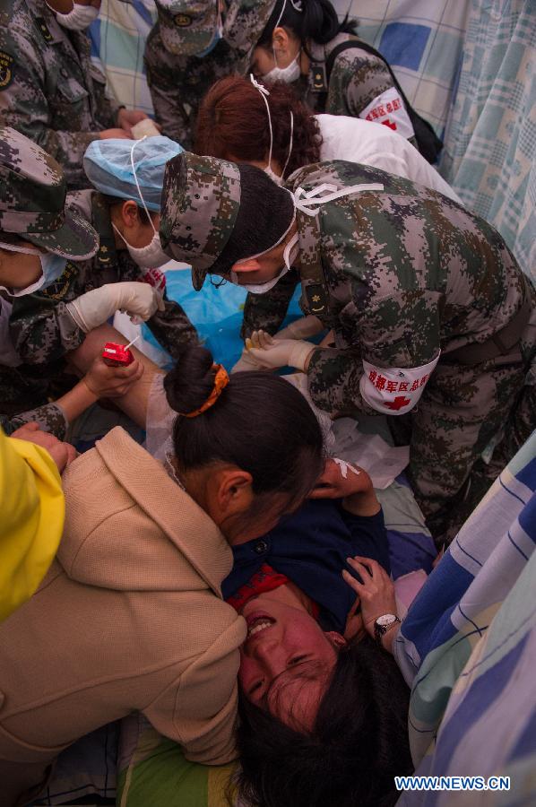 Medical workers take care of Yang Yan, a 20-year-old woman, in childbirth in a tent functioned as temporary hospital in quake-hit Taiping Township of Lushan County, southwest China's Sichuan Province, April 23, 2013. Yang's son was born later, and both mother and baby were fine. Yang and her husband Chen Wei arrived at the hospital in the early morning on Tuesday, after taking a long journey for over three hours from their home in Xingmin Village of the Taiping Township. This was the fourth day after a 7.0-magnitude earthquake jolted Lushan County on April 20. (Xinhua/Chen Cheng)