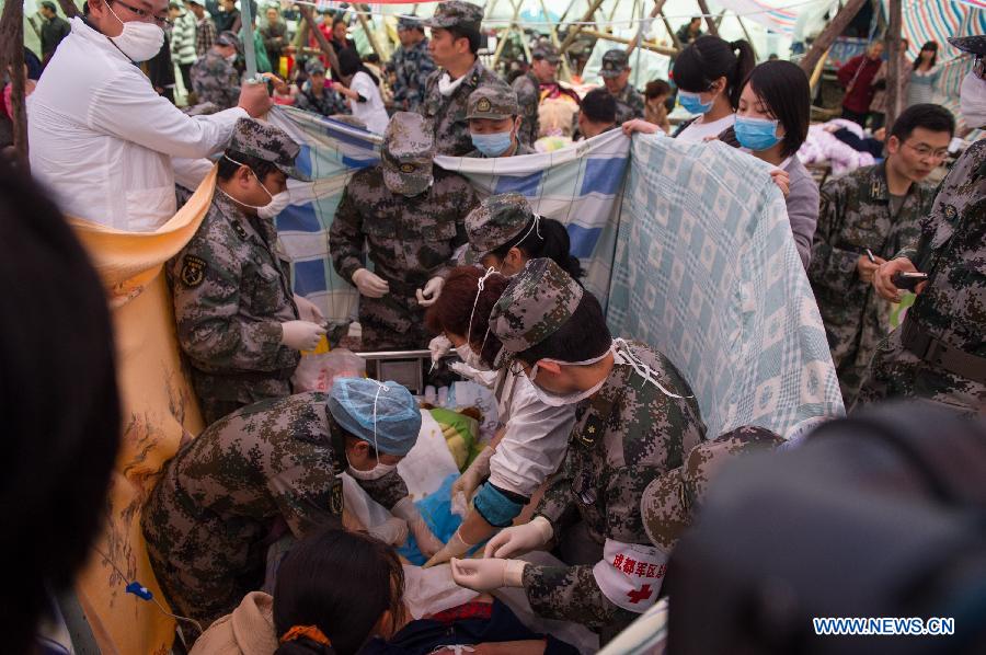 Medical workers take care of Yang Yan, a 20-year-old woman, in childbirth in a tent functioned as temporary hospital in quake-hit Taiping Township of Lushan County, southwest China's Sichuan Province, April 23, 2013. Yang's son was born later, and both mother and baby were fine. Yang and her husband Chen Wei arrived at the hospital in the early morning on Tuesday, after taking a long journey for over three hours from their home in Xingmin Village of the Taiping Township. This was the fourth day after a 7.0-magnitude earthquake jolted Lushan County on April 20. (Xinhua/Chen Cheng)