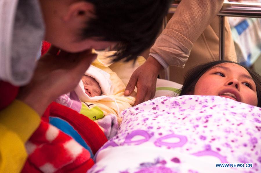 Yang Yan, a 20-year-old new mother, stays together with her newborn son in a tent functioned as temporary hospital in quake-hit Taiping Township of Lushan County, southwest China's Sichuan Province, April 23, 2013. Both mother and baby were fine. Yang and her husband Chen Wei arrived at the hospital in the early morning on Tuesday, after taking a long journey for over three hours from their home in Xingmin Village of the Taiping Township. This was the fourth day after a 7.0-magnitude earthquake jolted Lushan County on April 20. (Xinhua/Liu Jinhai)