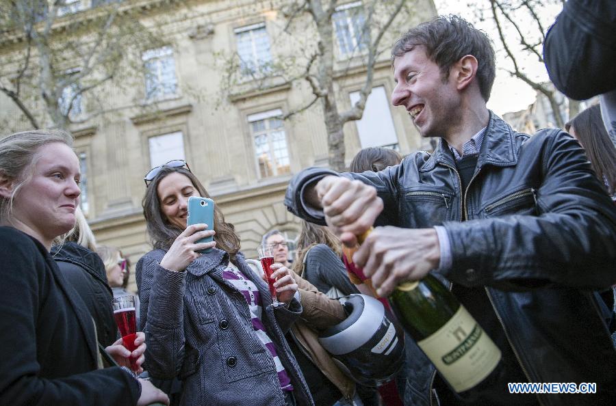 Supporters celebrate after France's legislators give the green light to same-sex couples to marry and adopt children in Paris, April 23, 2013. As the ruling Socialist Party (PS) enjoys an absolute majority at the National Assembly where 331 legislators voted for the bill and 225 voted against, it successfully paved the way for France to join dozens of other countries, mostly in Europe, to allow same-sex unions and adoption.(Xinhua/Etienne Laurent) 