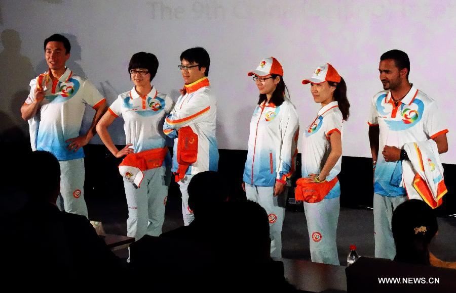 Volunteers present the costumes designed for the volunteers of the ninth China (Beijing) International Garden Expo at a press conference in Beijing, capital of China, April 23, 2013. The mascot for volunteers is given a nickname of "Little V Bee" as V stands for victory and bee is a symbol of diligence in Chinese culture. A total of 51,096 people have so far registered for the volunteer service during the expo. (Xinhua/Li Xin) 