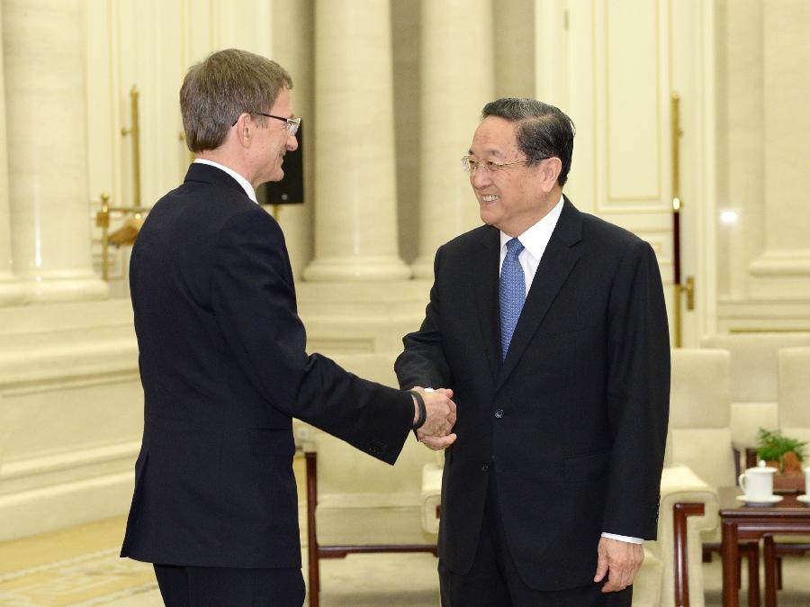 Yu Zhengsheng (R), chairman of the National Committee of the Chinese People's Political Consultative Conference, shakes hands with Nikolai Levichev, leader of the Russia of Justice party and deputy chairman of the State Duma, in Beijing, capital of China, April 25, 2013. (Xinhua/Ma Zhancheng)