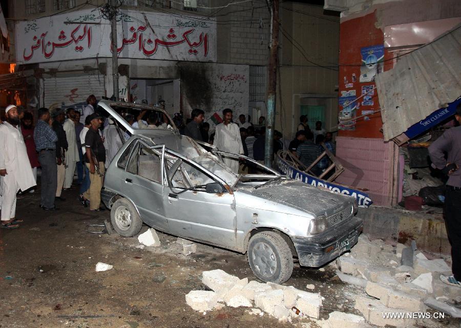 A destroyed vehicle is seen at the blast site in southern Pakistani port city of Karachi on April 25, 2013. At least five people were killed and 14 others injured in a bomb blast that hit a political gathering in Pakistan's southern port city of Karachi, local media and police said. (Xinhua/Arshad) 