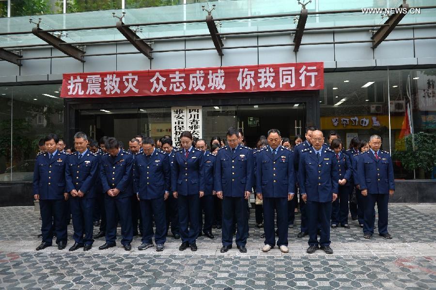 Staff members from Ya'an Administration for Industry and Commerce mourn for those who died in a 7.0-magnitude quake a week ago, in Ya'an City, southwest China's Sichuan Province, April 27, 2013. Public mourning was held on Saturday morning in Sichuan Province for those who died in a 7.0-magnitude quake a week ago. The earthquake hit Lushan County of Sichuan Province on April 20 and has claimed nearly 200 lives. (Xinhua/Li Xin)