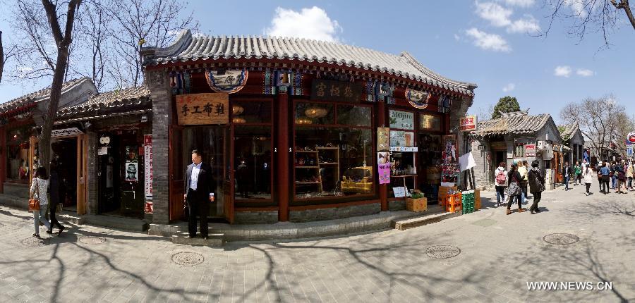 Tourists visit Nanluoguxiang, one of Beijing's oldest hutong neighborhoods, in Dongcheng District in Beijing, capital of China, April 27, 2013. Local administration has taken a series of measures to protect Hutong, ancient architecture and courtyards in Dongcheng District, including renovation and putting up brands with Chinese-English bilingual introduction for old buildings. (Xinhua/Li Xin)  