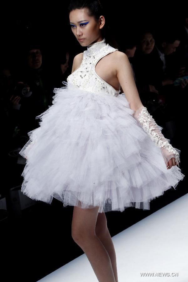 A model presents a creation designed by graduates from the College of Art and Design of Wuhan Textile University during the China Graduate Fashion Week in Beijing, capital of China, April 27, 2013. (Xinhua/Li Mingfang) 