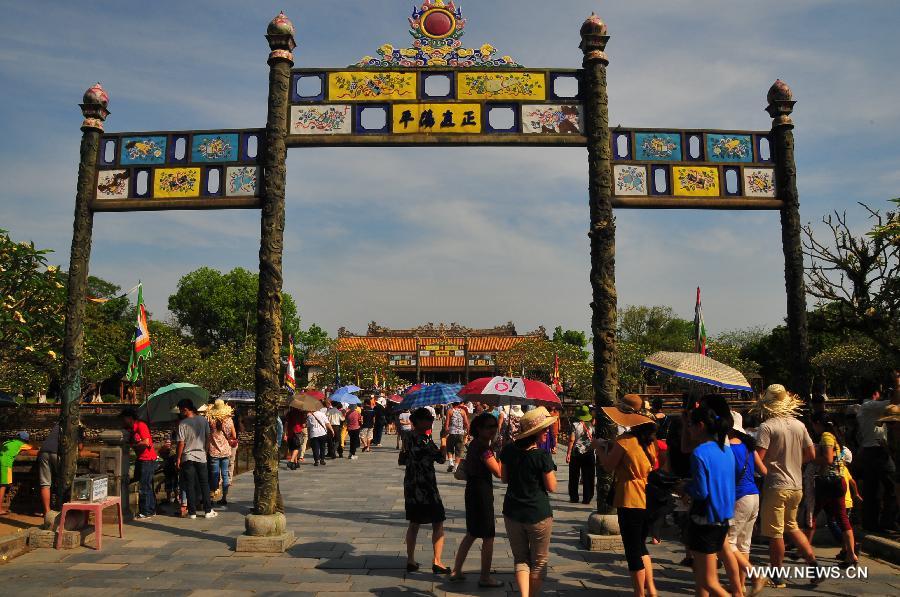 People enter a construction in Hue, a famous historic and cultural city in central Vietnam, April 28, 2013. Hue was the capital of Nguyen Dynasty, the country's last feudal dynasty. Hue was recognized by the United Nations Educational, Scientific and Cultural Organization as a World Heritage in 1993. (Xinhua/Zhang Jianhua) 