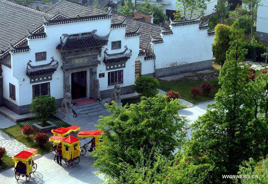 Pedicabs wait for tourists in front of the Sanhe Ancient Town Folklore Museum in Sanhe Town of Feixi County, east China's Anhui Province, April 24, 2013. The Sanhe Ancient Town, which has a history of more than 2,500 years, is a typical "ancient town full of rivers and lakes, together with small bridges, flowing water and local dwellings." (Xinhua/Wang Song)