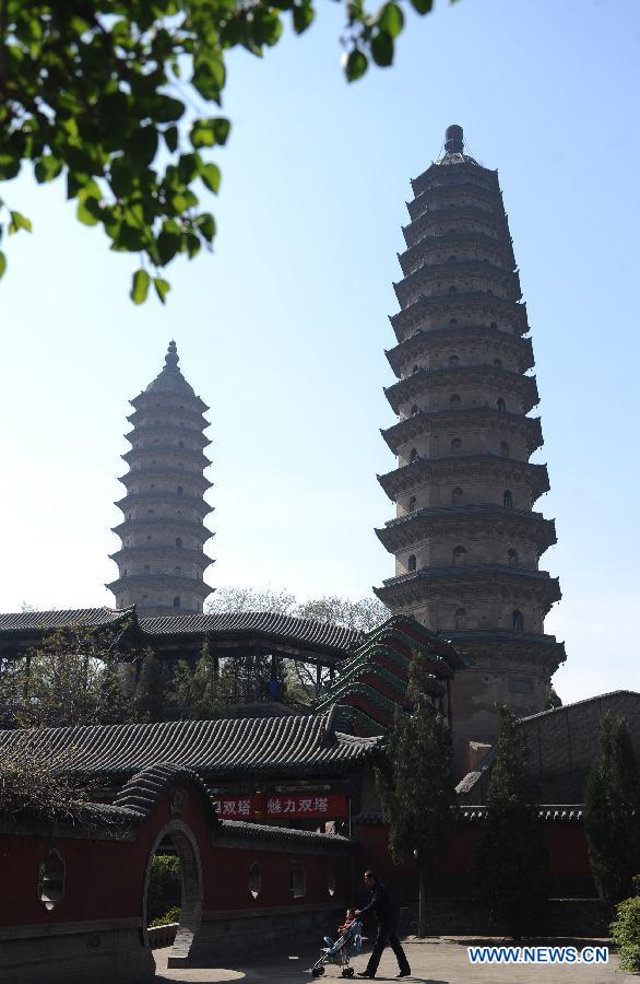 Twin pagodas are pictured at the Yongzuo Temple in Taiyuan, capital of north China's Shanxi Province, April 24, 2013. The well preserved pagodas, namely Wenfeng Pagoda and Xuanwen Pagoda, have a history of 400 years. With the height exceeding 54 meters, the pagodas overlook the city's existing ancient architectures and have been dubbed as the cultural landmark of Taiyuan. (Xinhua/Yan Yan)
