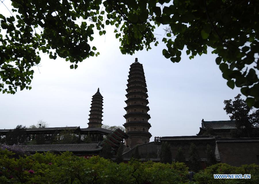 Twin pagodas are pictured at the Yongzuo Temple in Taiyuan, capital of north China's Shanxi Province, April 29, 2013. The well preserved pagodas, namely Wenfeng Pagoda and Xuanwen Pagoda, have a history of 400 years. With the height exceeding 54 meters, the pagodas overlook the city's existing ancient architectures and have been dubbed as the cultural landmark of Taiyuan. (Xinhua/Yan Yan)