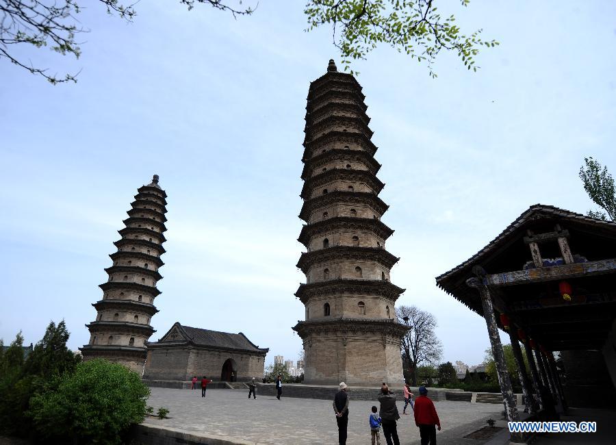 Twin pagodas are pictured at the Yongzuo Temple in Taiyuan, capital of north China's Shanxi Province, April 29, 2013. The well preserved pagodas, namely Wenfeng Pagoda and Xuanwen Pagoda, have a history of 400 years. With the height exceeding 54 meters, the pagodas overlook the city's existing ancient architectures and have been dubbed as the cultural landmark of Taiyuan. (Xinhua/Yan Yan)