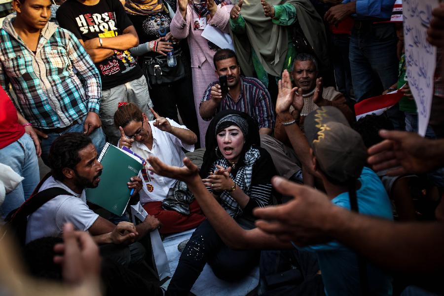 Egyptian workers and activists chant anti-Government slogans during a protest in Tahrir square marking the world Labour day in Cairo, May 1, 2013. Dozens of national factories and companies were sold to the private sector during Hosni Mubarak's regime causing unemployment of thousands of Egyptian workers whom still lacking proper work today. (Xinhua/Amru Salahuddien) 