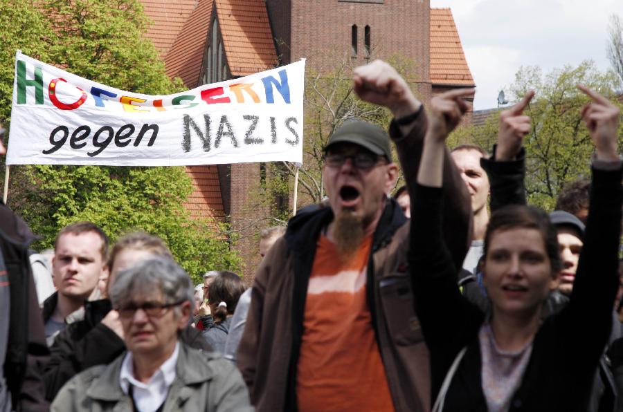 People call for action against the demonstratIion of the far-right extremist party NPD, on the street of Berlin, May 1, 2013. Thousands Berlin citizens launch a counter demonstration to condemn the the far right extremist forces. (Xinhua/Pan Xu) 