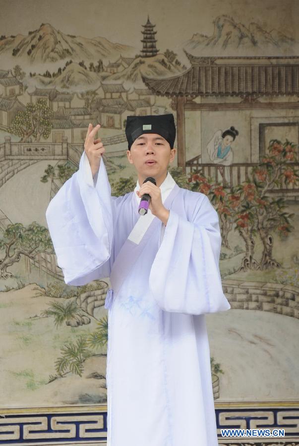 A man wears long robes of the archaic costumes typical of the Han Dynasty (202 BC - 221 AD) during a presentation event promoting the Han costumes and traditional etiquette in Fuzhou, capital of southeast China's Fujian Province, May 1, 2013. (Xinhua/Lin Shanchuan)