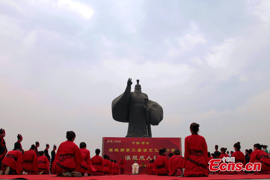 Young people, dressed in traditional Han costumes, attend the Coming-of-Age ceremony in Xi'an, the capital city of Shaanxi Province, May 1, 2013. Altogether 40 people took part in the ceremony to be recognized as an adult. (CNS/Zhang Yuan)