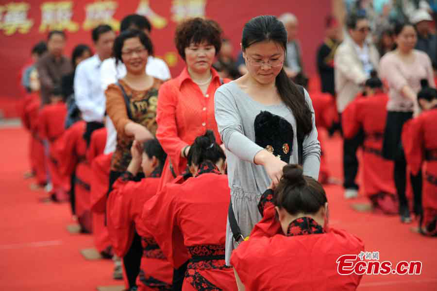 Young people, dressed in traditional Han costumes, attend the Coming-of-Age ceremony in Xi'an, the capital city of Shaanxi Province, May 1, 2013. Altogether 40 people took part in the ceremony to be recognized as an adult. (CNS/Zhang Yuan)